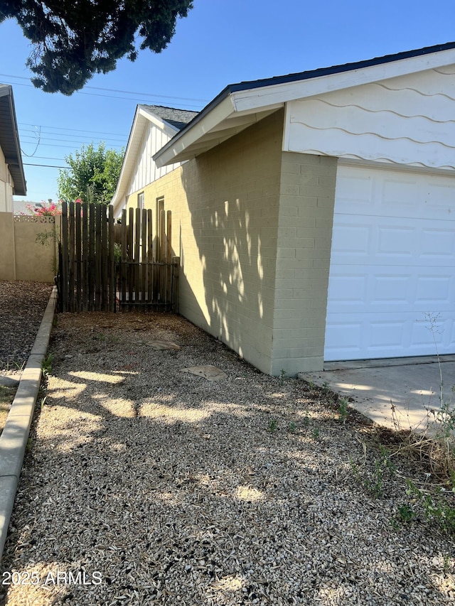 8257 E Cypress St, Scottsdale, AZ 85257 - view of home's exterior featuring a garage and board and batten siding