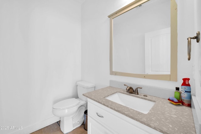 half bath featuring toilet and vanity