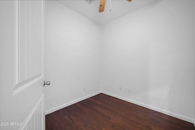 unfurnished room with ceiling fan, baseboards, and dark wood-type flooring