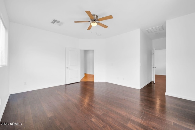 spare room with ceiling fan, hardwood / wood-style flooring, visible vents, and baseboards