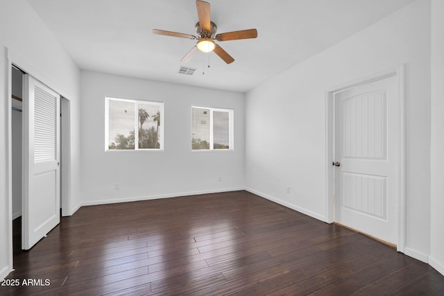 unfurnished bedroom featuring a closet, visible vents, ceiling fan, baseboards, and hardwood / wood-style flooring