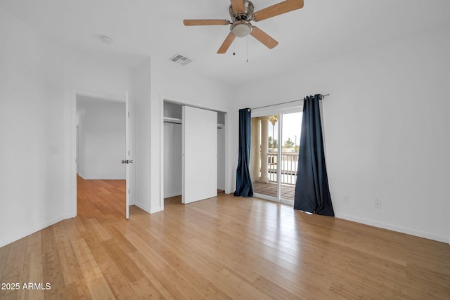 unfurnished bedroom featuring light wood finished floors, baseboards, visible vents, access to exterior, and a closet