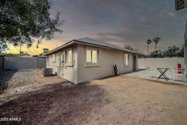 view of property exterior with cooling unit, a patio area, a fenced backyard, and stucco siding