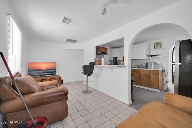 living room with visible vents and light tile patterned flooring