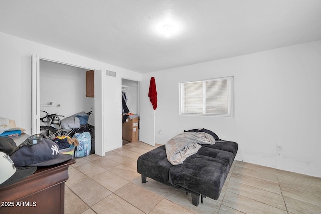 living area with light tile patterned floors and visible vents