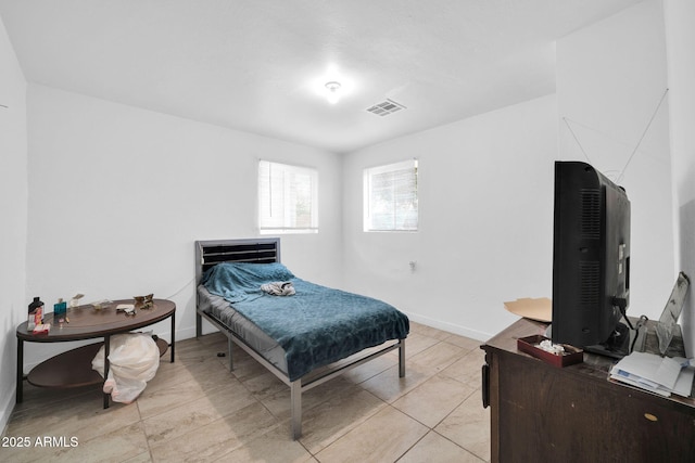 bedroom with visible vents, baseboards, and light tile patterned floors