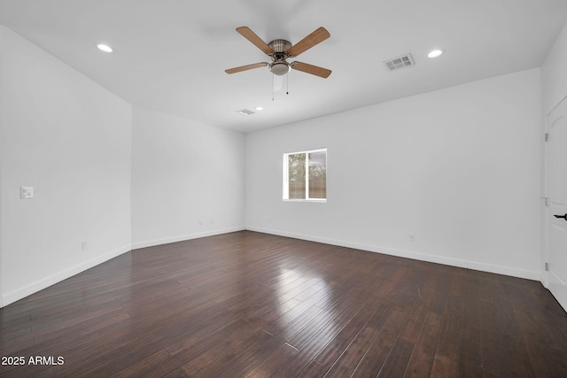 unfurnished room featuring baseboards, visible vents, ceiling fan, and wood finished floors