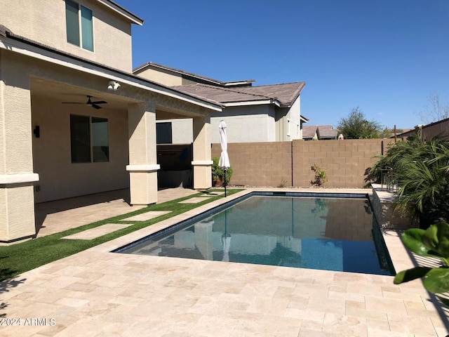 view of swimming pool featuring ceiling fan and a patio area