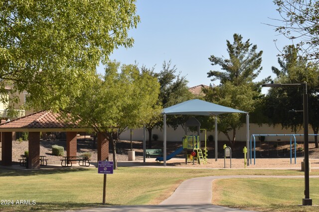 view of property's community featuring a playground, a gazebo, and a lawn