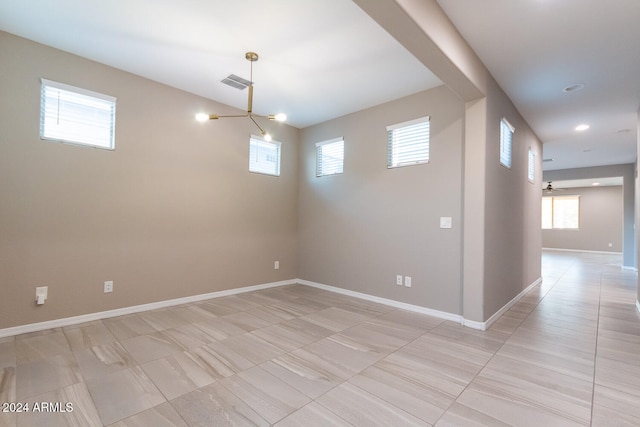 basement featuring plenty of natural light and a chandelier