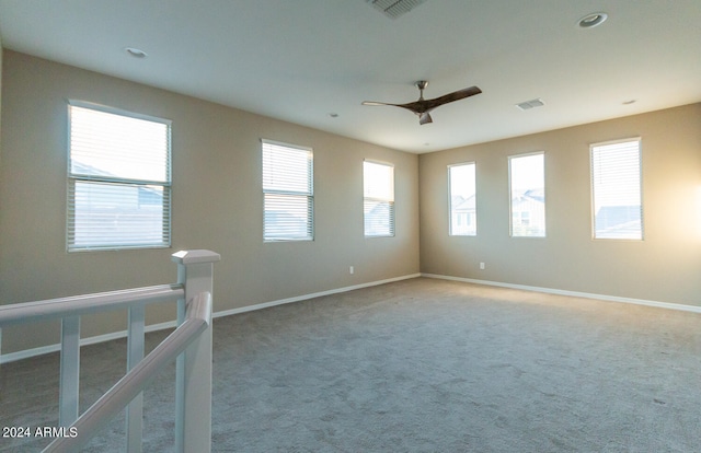 carpeted empty room featuring ceiling fan