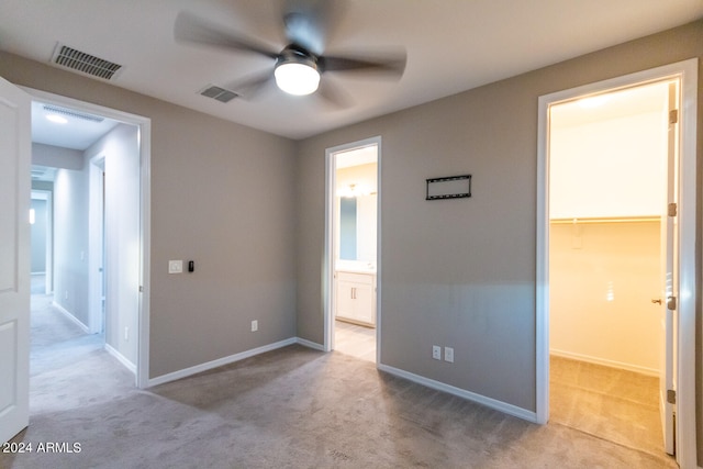 interior space with ceiling fan and light carpet