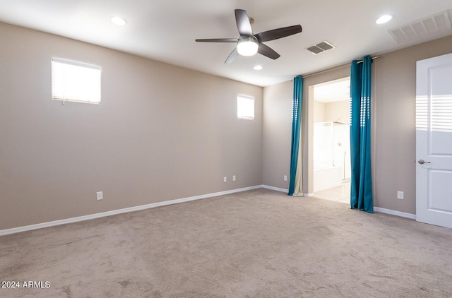 carpeted spare room featuring ceiling fan