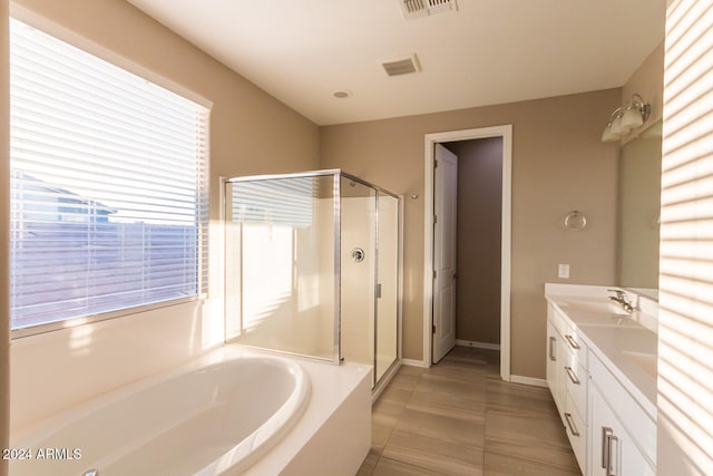 bathroom featuring plus walk in shower, tile patterned floors, and vanity