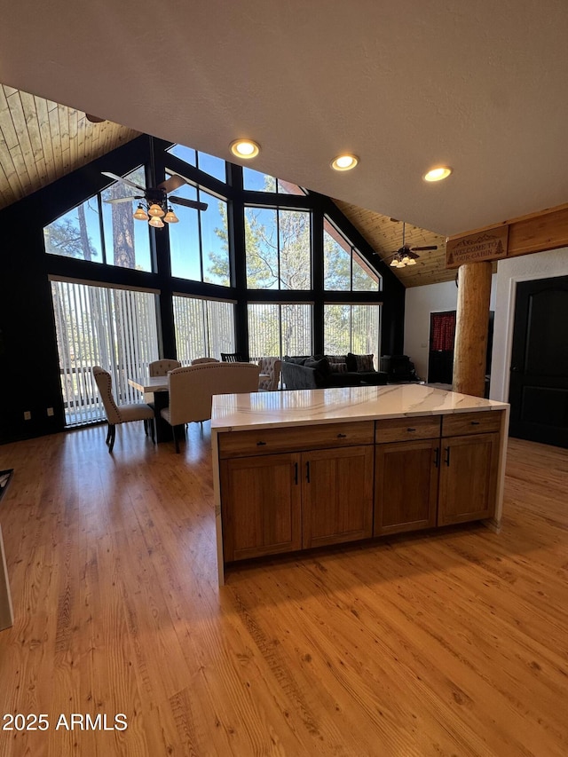 kitchen featuring a healthy amount of sunlight, light wood-style flooring, a ceiling fan, and light countertops