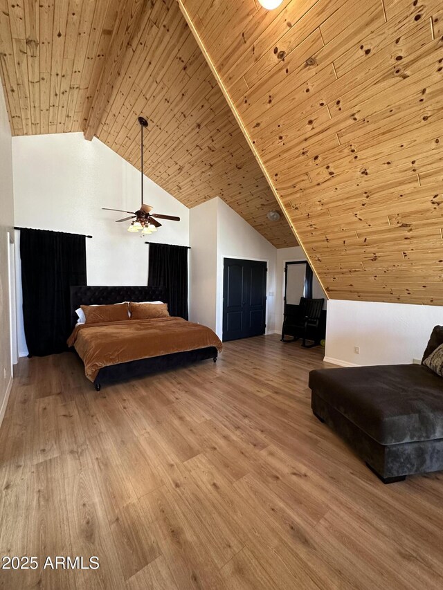 bedroom with high vaulted ceiling, wood ceiling, wood finished floors, and a ceiling fan