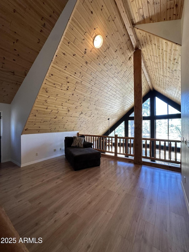 additional living space with high vaulted ceiling, wood ceiling, baseboards, and wood finished floors