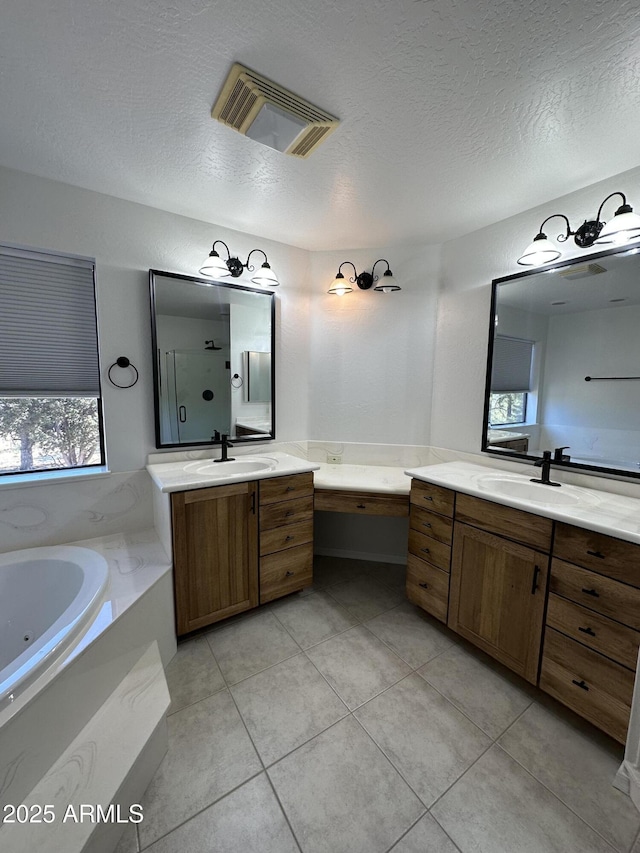 full bath with two vanities, visible vents, a whirlpool tub, and a sink