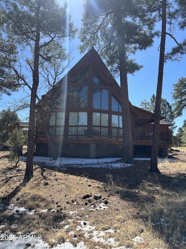 back of property with a wooden deck