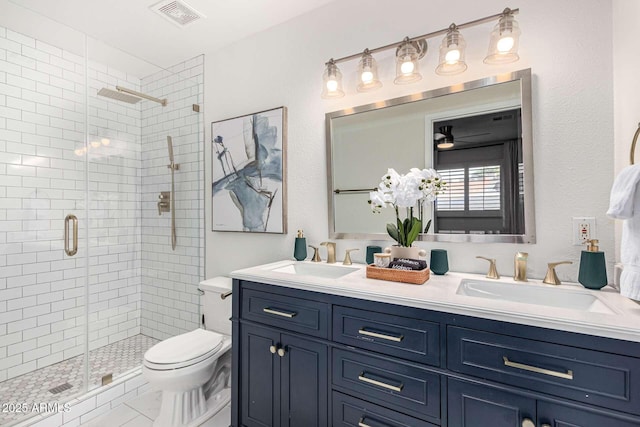 bathroom with vanity, toilet, and a shower with door