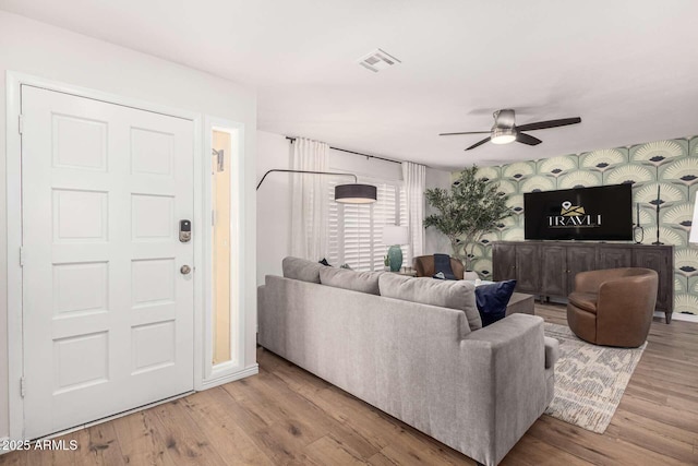 living room featuring hardwood / wood-style flooring and ceiling fan