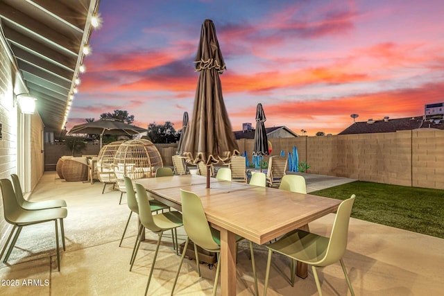 view of patio terrace at dusk