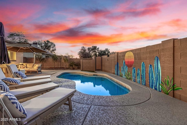 pool at dusk featuring a patio and outdoor lounge area