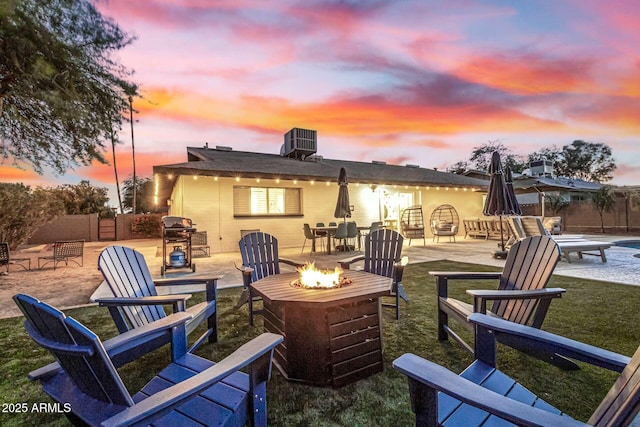 patio terrace at dusk with area for grilling and an outdoor fire pit