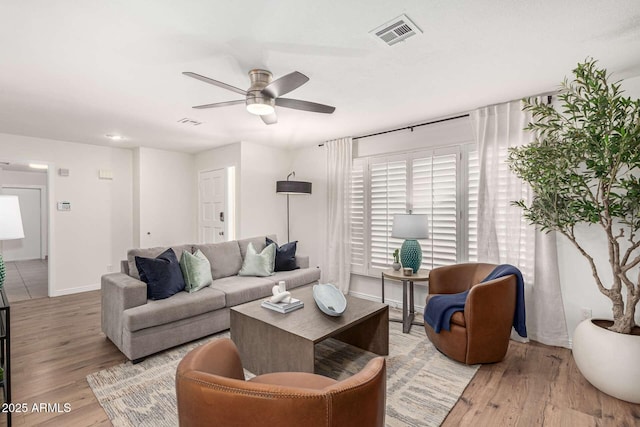 living room with ceiling fan and light wood-type flooring