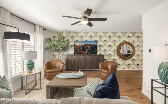 living room with ceiling fan, light hardwood / wood-style floors, and a wealth of natural light