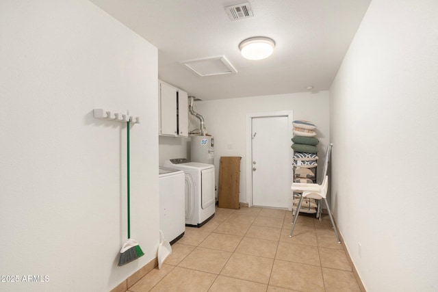 laundry room with light tile patterned flooring, cabinets, washer and clothes dryer, and electric water heater