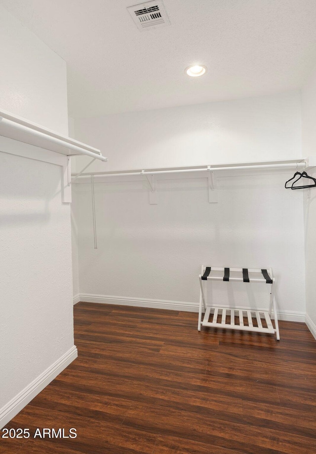 walk in closet featuring dark hardwood / wood-style flooring