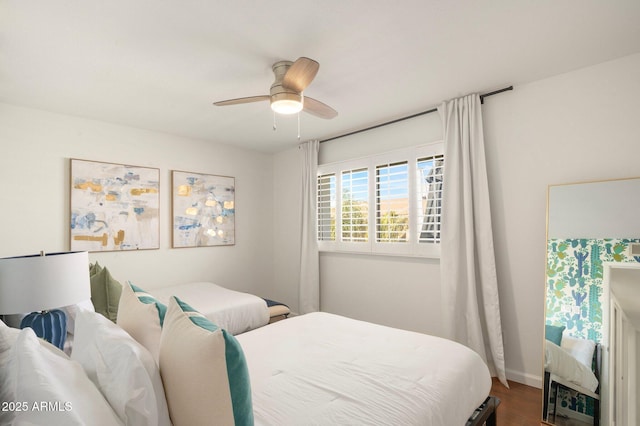 bedroom featuring wood-type flooring and ceiling fan