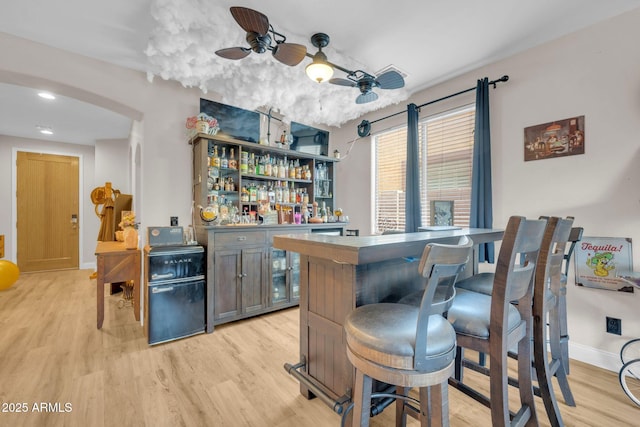 10613 E Knowles Ave, Mesa, AZ 85209 - indoor dry bar featuring light wood-style flooring, baseboards, arched walkways, a ceiling fan, and recessed lighting