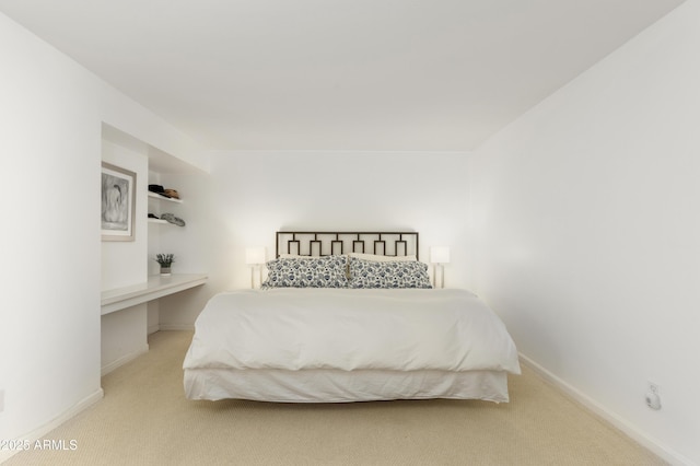 carpeted bedroom featuring baseboards