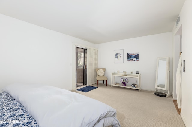 carpeted bedroom featuring visible vents