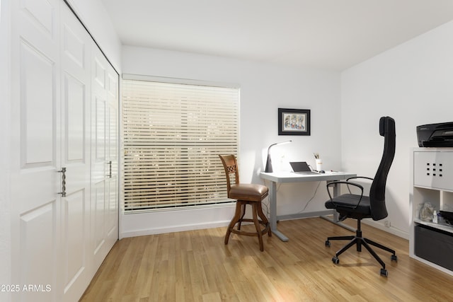 home office with light wood finished floors and baseboards