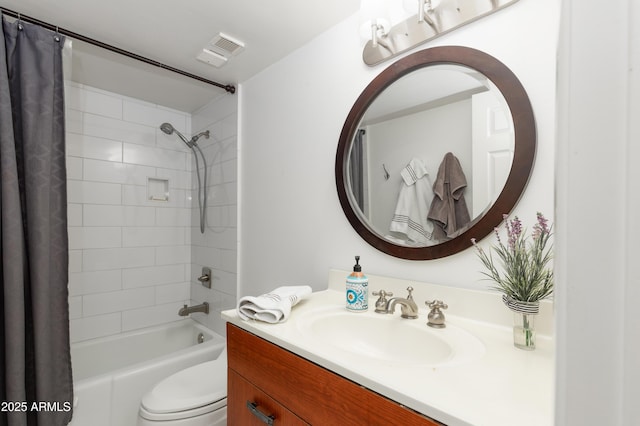 bathroom with visible vents, vanity, toilet, and shower / bath combo with shower curtain