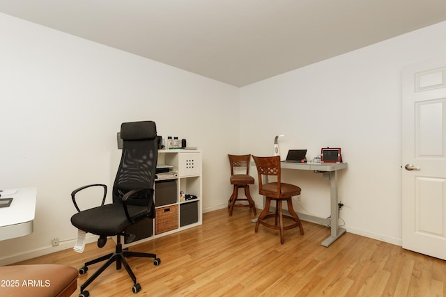 home office with light wood finished floors and baseboards