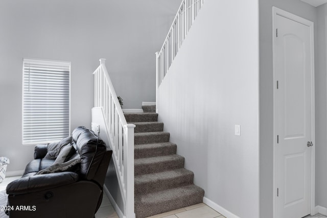 staircase with tile patterned floors