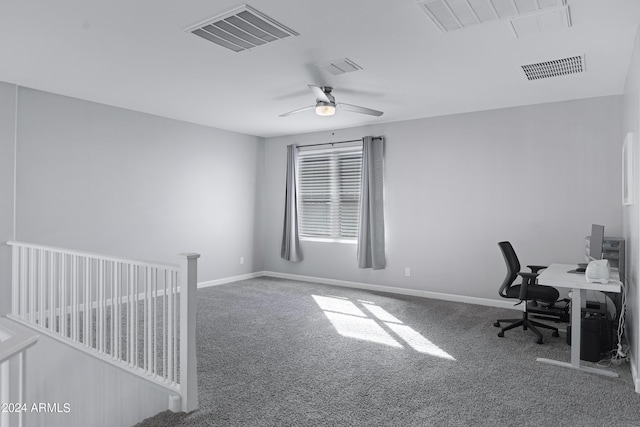 carpeted office space featuring ceiling fan