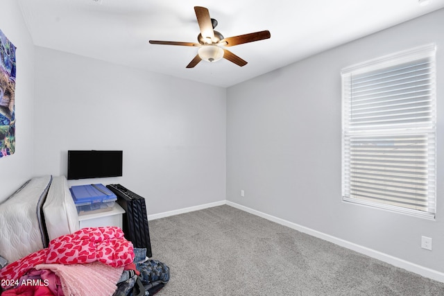 interior space featuring carpet flooring and ceiling fan