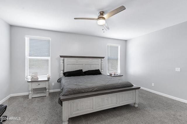 carpeted bedroom with multiple windows and ceiling fan