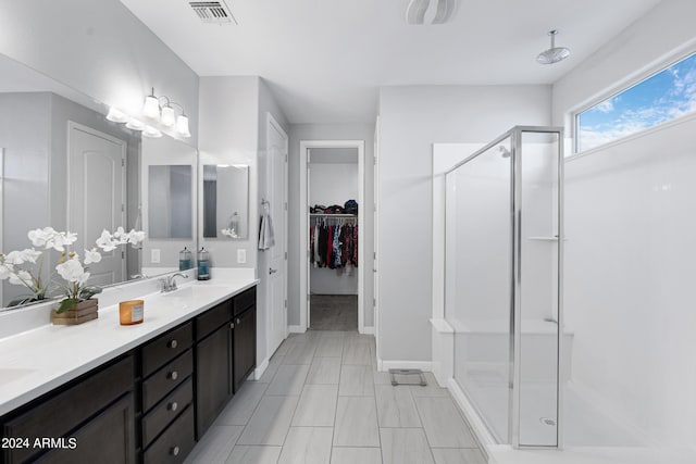 bathroom featuring vanity and a shower with shower door