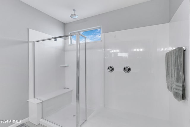 bathroom with a tile shower