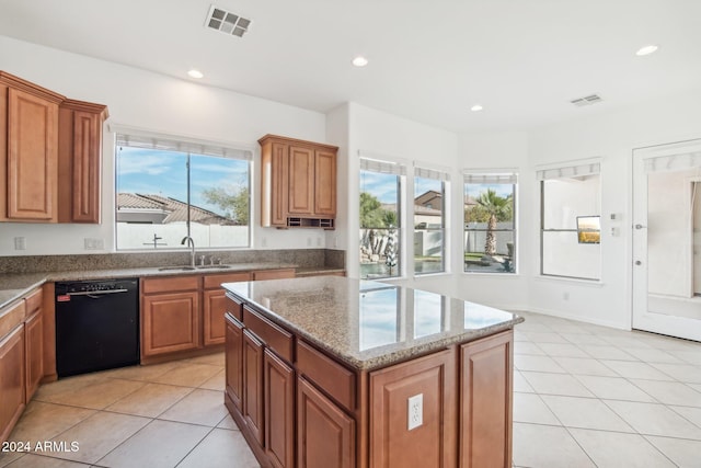 kitchen featuring a center island, a healthy amount of sunlight, sink, and black dishwasher