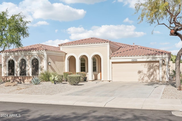 mediterranean / spanish-style house with a garage