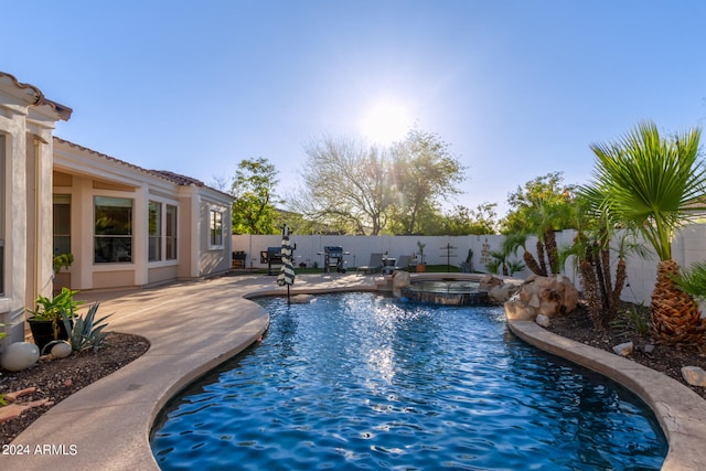 view of pool featuring a patio area and an in ground hot tub