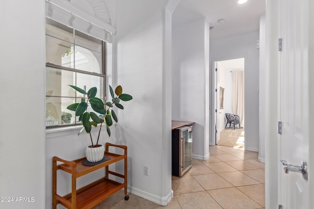 hall featuring light tile patterned floors