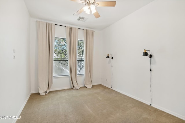 unfurnished room featuring light carpet and ceiling fan